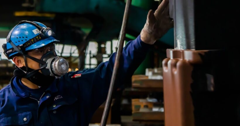Industrial worker using protective equipment during air monitoring and controlled reentry