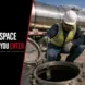 Workers conduct atmospheric testing and review an entry permit before entering a tanker trailer confined space.
