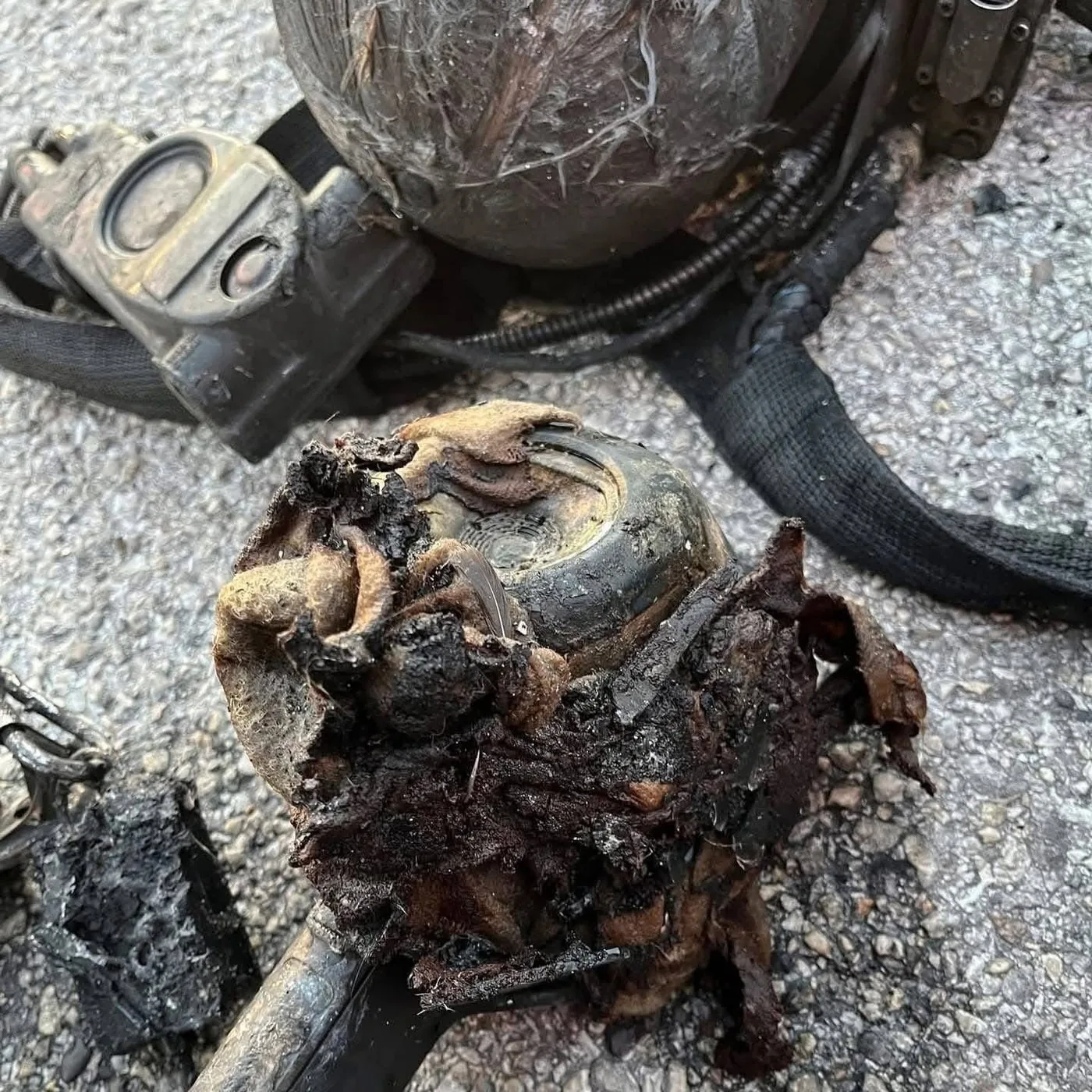 SCBA low-pressure regulator showing severe thermal damage and melting after the Houston apartment flashover