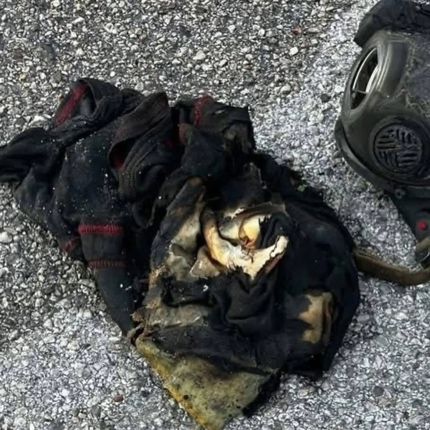 Firefighter hood and coat showing severe heat exposure after the Houston apartment flashover