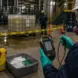 Worker isolating a chemical spill while determining whether emergency HAZWOPER response is required.