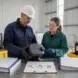 Workers examine a waste container while completing a hazardous-waste determination