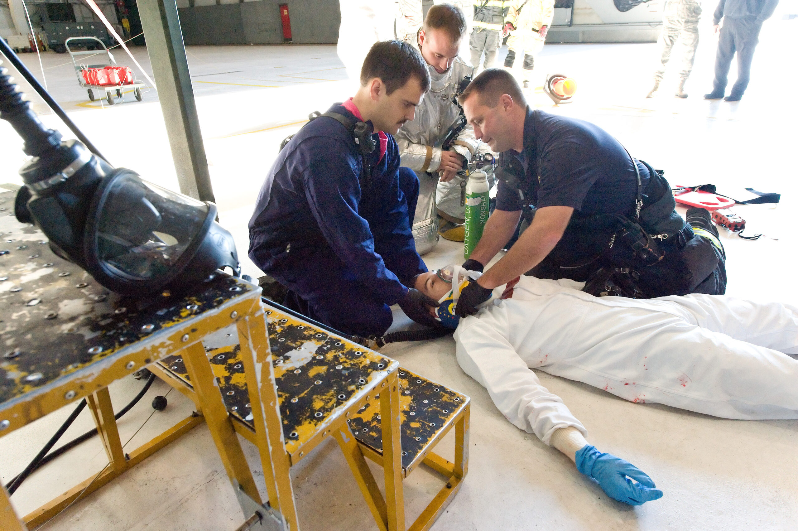 Fire department first responders provide care to a simulated victim during a confined space rescue training exercise at Dover Air Force Base.
