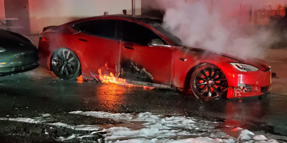 Electric vehicle battery fire with smoke visible, the kind of incident where SCBA discipline matters.