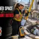 Confined space attendant monitoring a permit-required space entry with atmospheric monitoring and retrieval equipment.