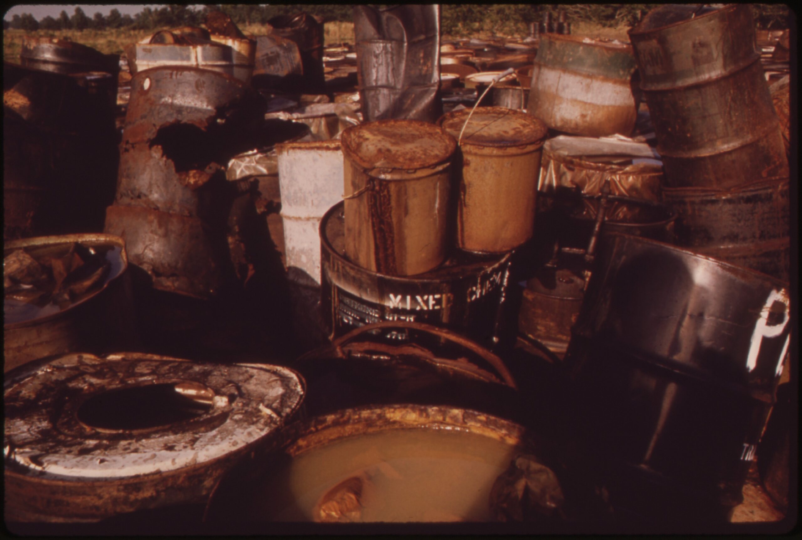 Damaged and deteriorating drums containing hazardous industrial waste at a historic EPA-documented waste site