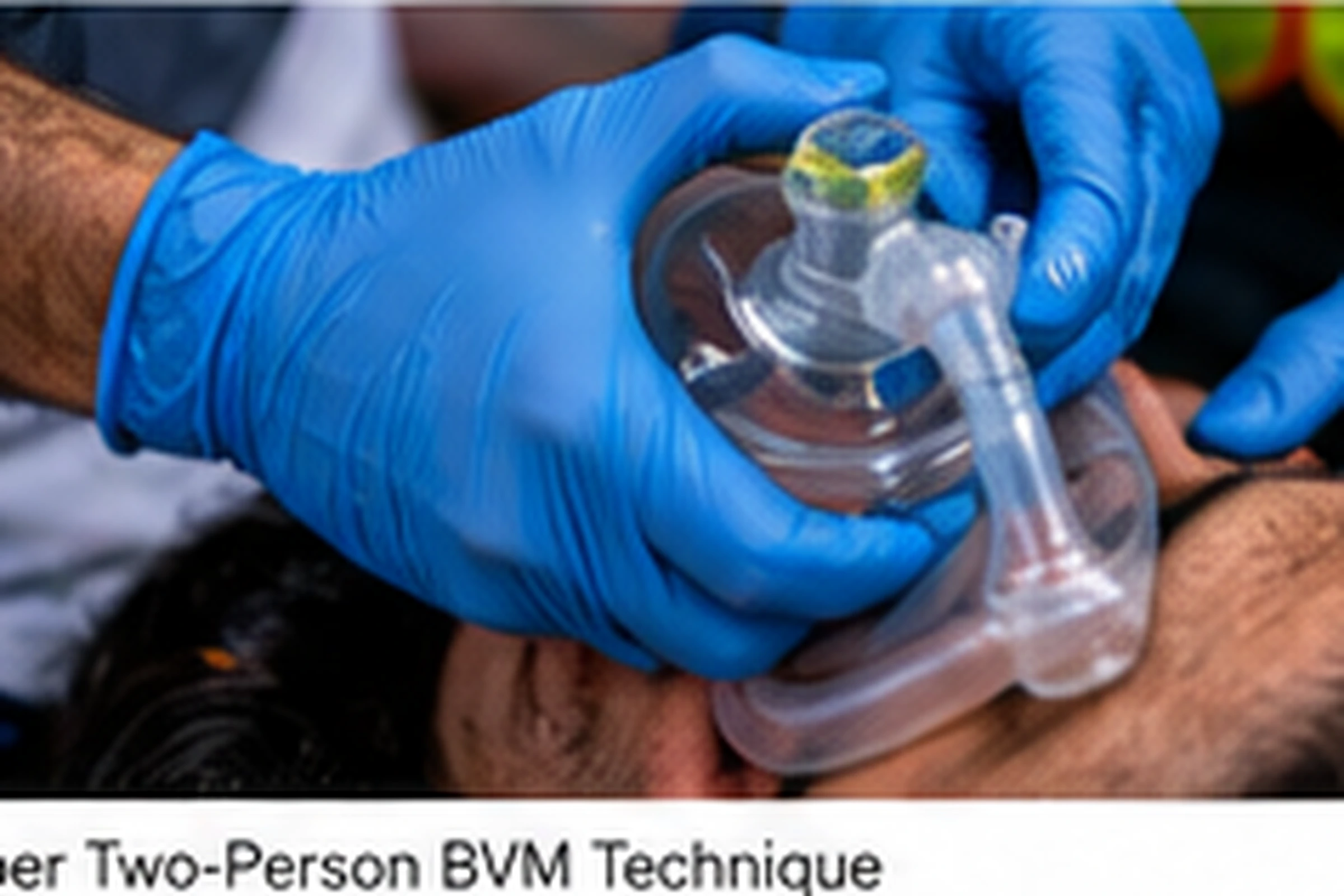 Two responders using a two-person bag-valve-mask technique during airway management training