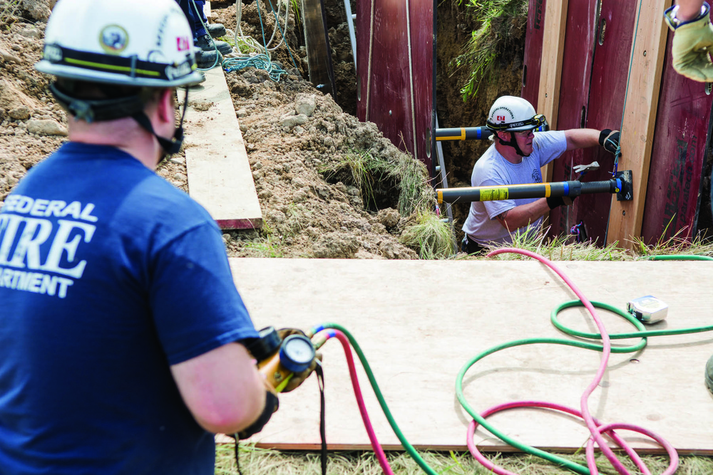 Firefighters participate in a trench-rescue field exercise.