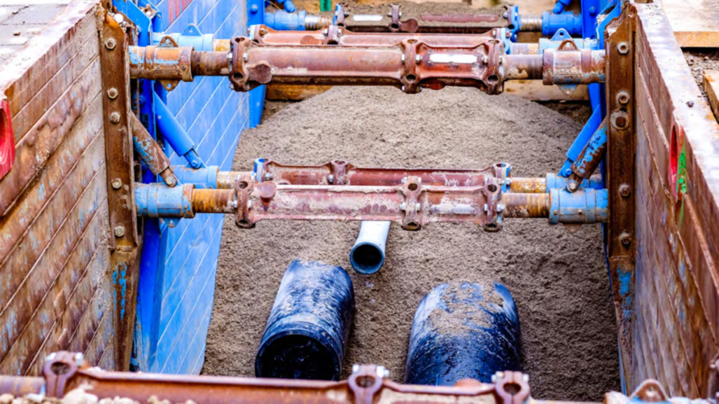 Hydraulic shoring installed inside a construction trench as an OSHA trench safety protective system.